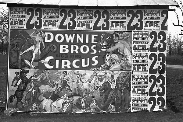 CIRCUS ADVERTISEMENT, 1936. Billboard posters covering the side of a building advertising the Downie Brothers three ring circus near Lynchburg, South Carolina. Photograph by Walker Evans, 1936