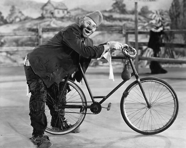 CIRCUS: CLOWN, c1920. Clown Joe Jackson, Sr. (nÔÇÜ Joseph Francis Jiranek, 1873-1942) with the bicycle used in his act. Photographed c1920