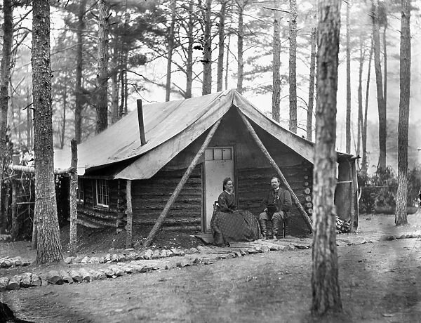CIVIL WAR: LOG CABIN, 1864. Colonel John R. Coxe seated with a lady in front of his log cabin at the winter quarters at the Army of the Potomac headquarters at Brandy Station, Virginia. Photograph, February 1864