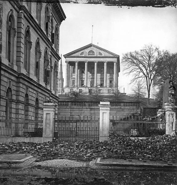 CIVIL WAR: RICHMOND, 1865. View of the Capitol building (center) and the Custom House(left), in Richmond, Virgina following the Civil War. Photograph, April 1865
