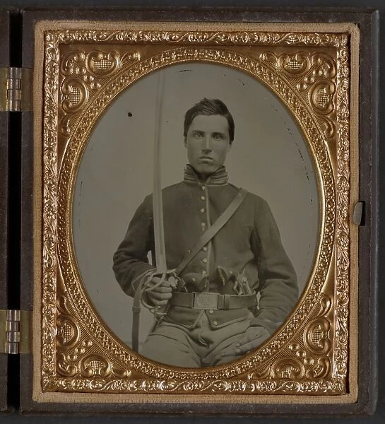 CIVIL WAR: SOLDIER, c1863. Portrait of a Union cavalry soldier holding a revolvers and a saber