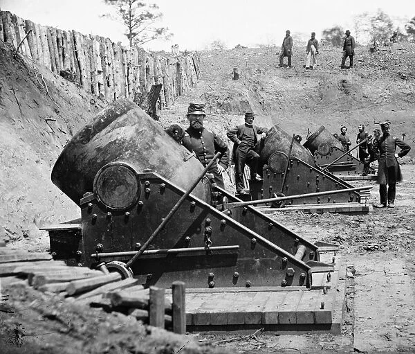 CIVIL WAR: UNION MORTARS. 13 inch seacoast mortars of the Federal Battery Number 4, with officers of the Connecticut Heavy Artillery, near Yorktown, Virginia. Photograph by James F. Gibson, May 1862