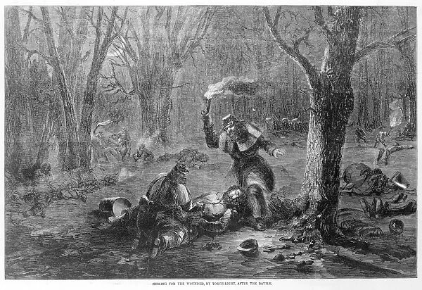 CIVIL WAR: WOUNDED. Searching for the wounded by torchlight after the Battle of Fort Donelson in 1862 during the Civil War. Woodcut