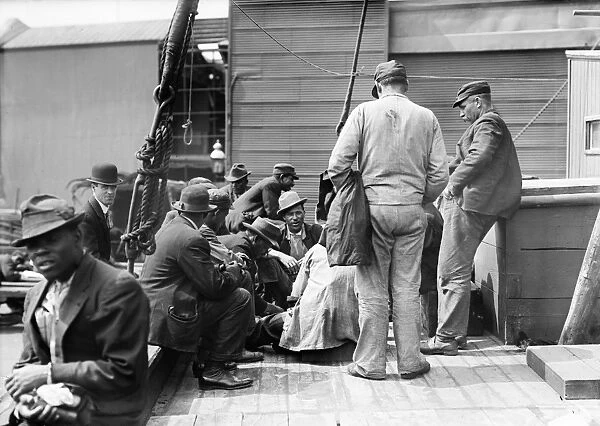 COAL PASSERS, 1911. Coal passers discussing a strike on the deck of a ship. Photograph