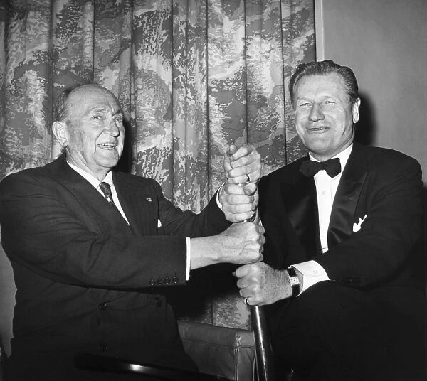COBB & ROCKEFELLER, 1960. American baseball player Ty Cobb (left) with New York Governor Nelson Rockefeller, holding Cobbs silver bat which he received as batting champion in 1911. Photographed at the 37th Annual Dinner of the New York Chapter of the Baseball Writers Association of America at the Astor Hotel in New York City, 31 January 1960