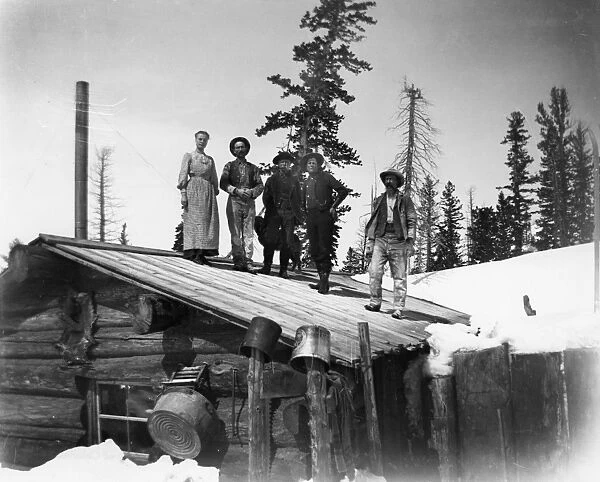 COLORADO: HOMESTEADERS. Homesteaders on the roof of their cabin, probably in Colorado