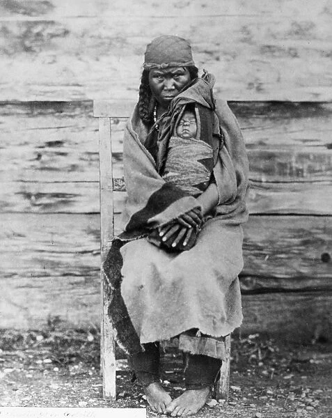 COLVILLE WOMAN & CHILD, 1861. A Colville Native American woman holding an infant in a cradleboard