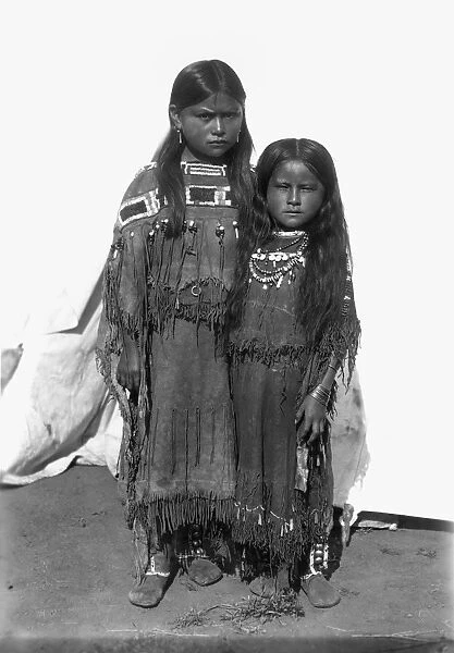 COMANCHE GIRLS, 1892. The girl on the left is the daughter of Quanah Parker. Oil over a photograph, 1892