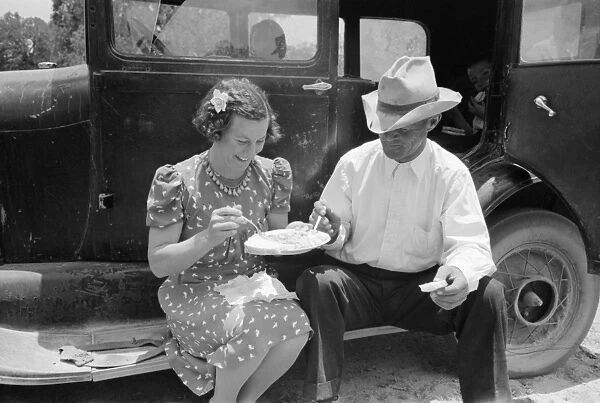 COMMUNITY DINNER, 1940. A couple eating dinner at the all-day community sing in Pie Town