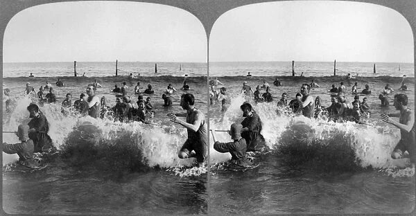 CONEY ISLAND: BEACH, c1903. Bathers in the breaking waves at Coney Island, Brooklyn, New York