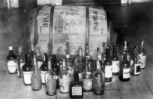 CONFISCATED WHISKEY, 1920s. Bottles and keg of whiskey confiscated during Prohibition in America