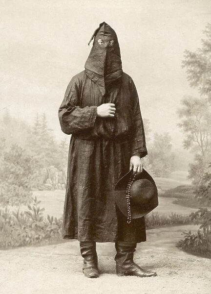 Costume worn by members of the Brotherhood of Mercy when dealing with victims of the plague. Studio photograph, Florence, Italy, c1900