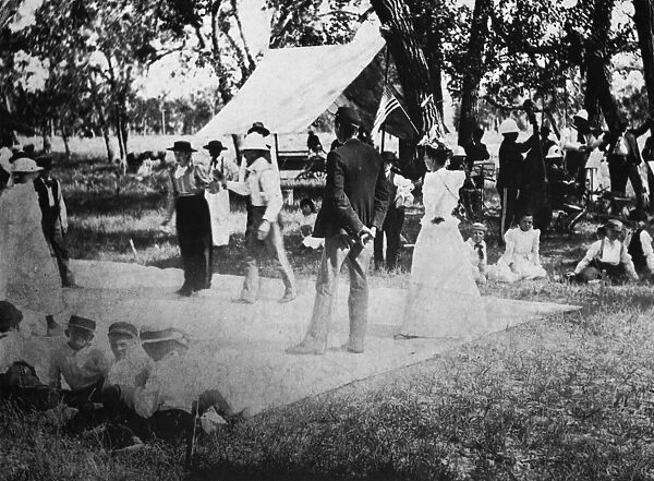 COUNTRY DANCE, 19th CENTURY. A canvas dance floor at an outdoor party in western America