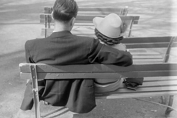 COUPLE, c1940. A couple on a bench. Photograph, c1940