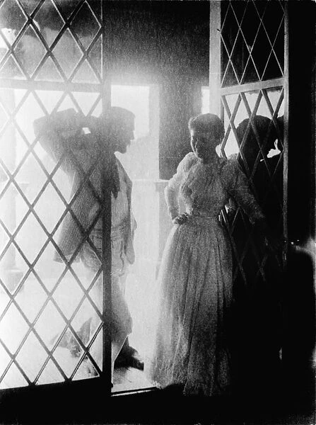 COUPLE IN DOORWAY. Man and woman at a doorway to a porch. Photograph by Emma Justine Farnsworth, late 19th or early 20th century