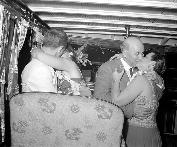 COUPLES KISSING, 1940. Couples kiss during a Venetian night party at the Detroit yacht club