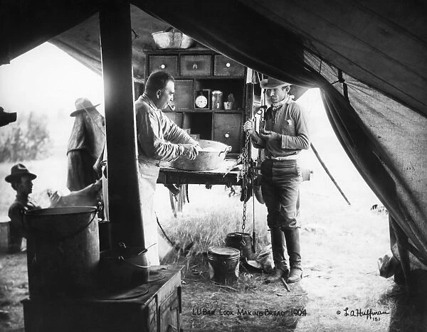 Cowboys making bread at a camp in Montana. Photograph by L. A. Huffman, 1904