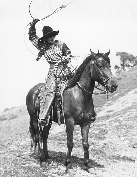 COWGIRL, c1920. Josie Sedgwick showing the use of a lariat. Photograph, c1920