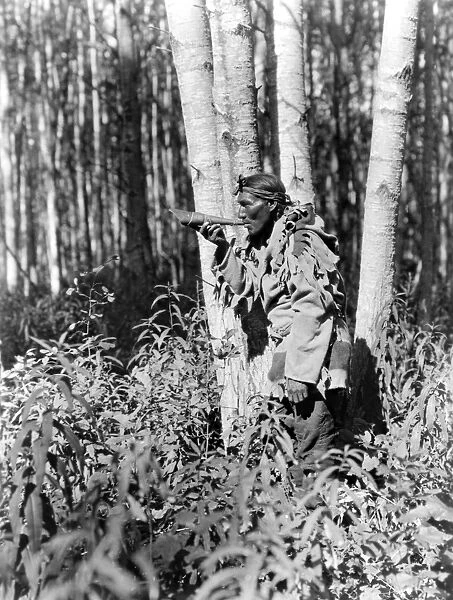 CREE HUNTER, c1927. A Cree hunter blowing a horn to call a moose. Photograph by Edward Curtis