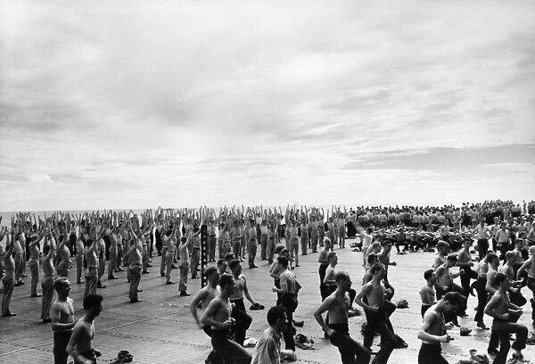 The crew of the aircraft carrier USS Lexington exercising on the flight deck during World War II. Photograph, c1943