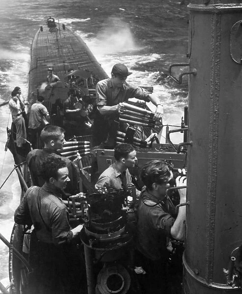 Crew members aboard a U. S. submarine practice firing as they return to base from a successful war patrol, 1945