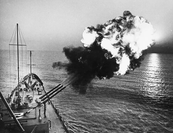 The cruiser U. S. S. Canberra fires a salvo against North Vietnam from the Gulf of Tonkin Photograph, n. d. but before March 1967