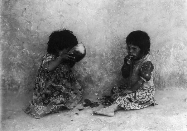 CURTIS: HOPI CHILDREN. Two Hopi children in Arizona eating melon. Photograph by Edward Curtis