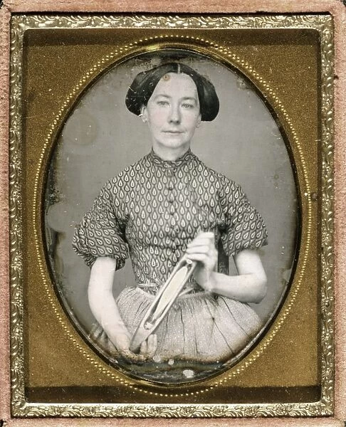 DAGUERREOTYPE: WOMAN. Portrait of Maria Boyd holding a weaving shuttle. Daguerreotype