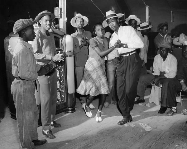 A dance in the recreation tent at a Farm Security Administration workers camp in Bridgeton, New Jersey. Photograph by John Collier, June 1942