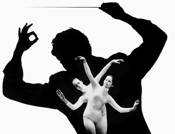 DANCER AND CONDUCTOR. Composite photograph of a young ballet dancer against a silhouette of an orchestra conductor, 1970s