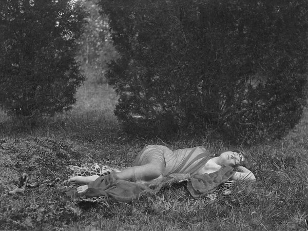 DAY: RECLINING WOMAN, c1897. Woman in sheer drapery reclining on a leopard skin