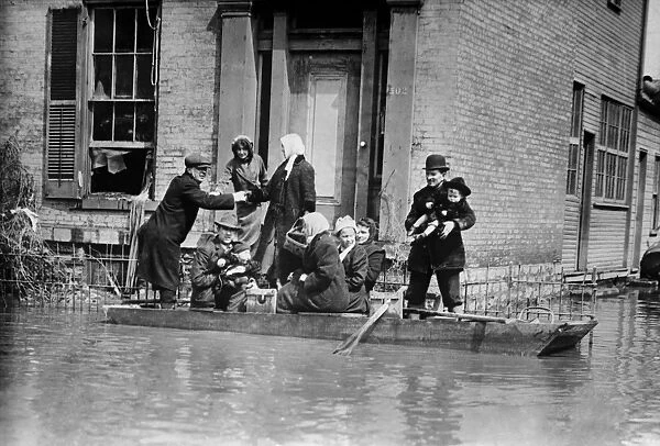 DAYTON FLOOD, 1913. Workers rescuing a family in a rowboat after the flood in Dayton, Ohio