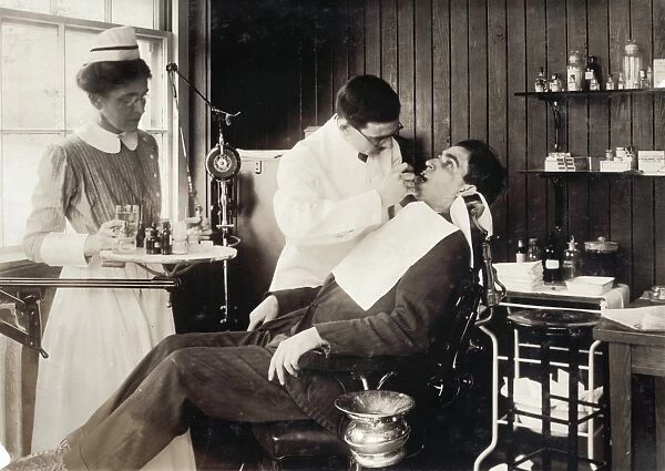 DENTISTRY, 1917. Dentist working on a patient in a hospital, Cambridge, Massachusetts