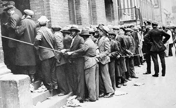 DEPRESSION: HARLEM, 1931. Men lined up outside an unemployment office in Harlem, New York City, 1931
