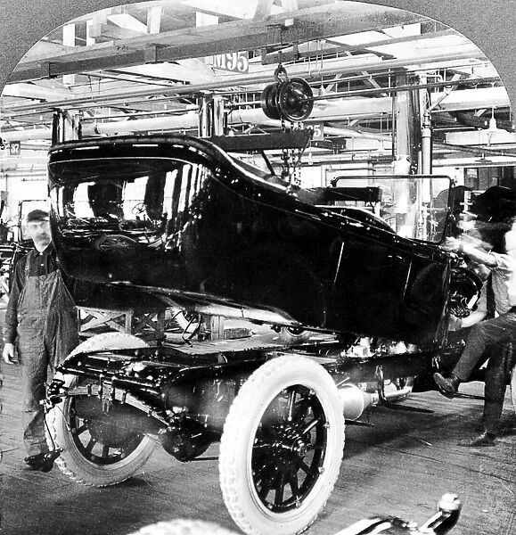 DETROIT: AUTO FACTORY, c1917. Mounting the automobile body onto a chassis, at an