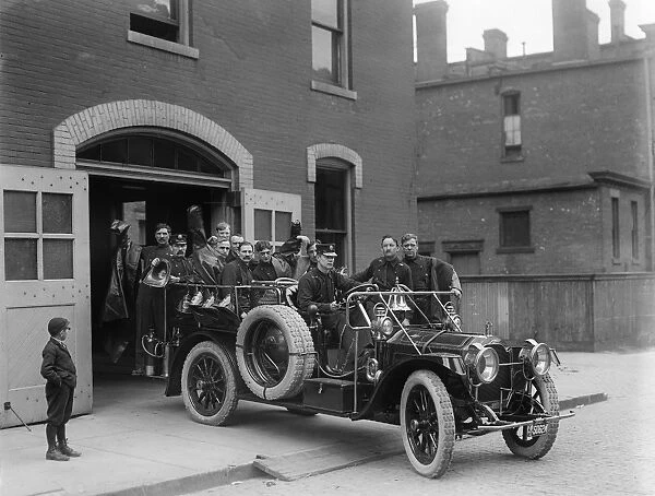 DETROIT: FIRETRUCK, 1911. A fire brigade aboard a fire engine manufactured by the
