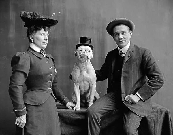 DOG TRAINERS, c1900. Mr. and Mrs. Frank Kern with their trained dog Bobbie. Photograph
