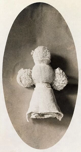 A doll made from waste material by a child in a knitting mill where mother works. Photograph by Lewis Wickes Hine, 1908