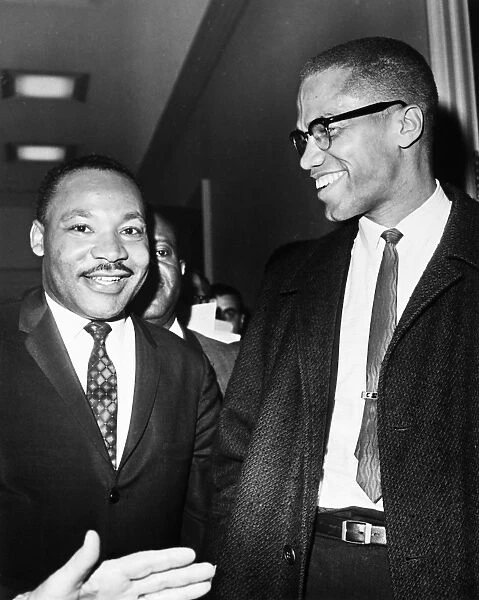 Dr. Martin Luther King Jr. (left), American cleric and civil rights leader, photographed with American religious and political leader Malcolm X at the Capitol in Washington, D. C. 26 March 1964