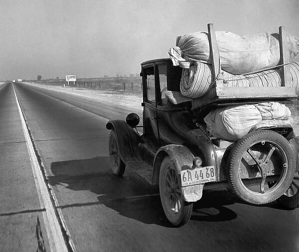 DROUGHT REFUGEE, 1936. Drought refugees traveling on U. S. Highway 99 between Bakersfield and Famoso, California. Photograph by Dorothea Lange, 1936