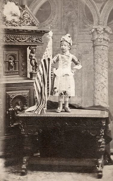 DWARF, c1880. Portrait of a dwarf woman standing on a desk next to an American flag
