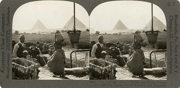 EGYPT: PUMPING WATER, c1920. The old and new in Egypt - a water carrier and a