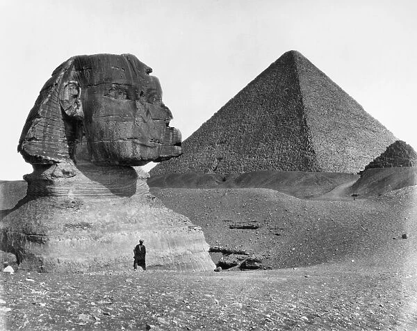 EGYPT: SPHINX AND PYRAMID. A view of the Great Sphinx at Giza, Egypt, partially excavated