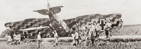 An elaborately camouflaged German fighter plane brought down by a French Canon de 75 anti-aircraft gun during World War I. Photograph, c1916