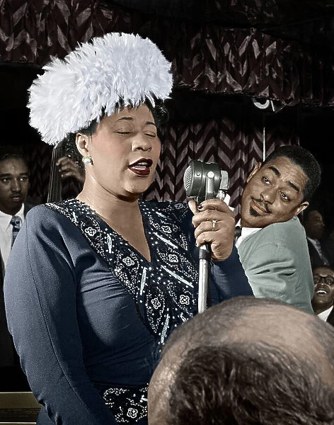 ELLA FITZGERALD (1917-1996). American singer. Performing on stage with Dizzy Gillespie