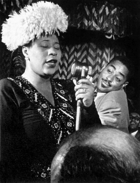 ELLA FITZGERALD (1917-1996). American singer. Performing on stage with Dizzy Gillespie, 1947
