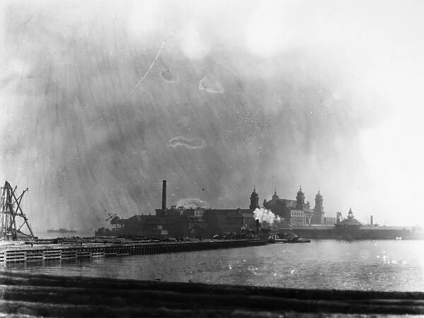 ELLIS ISLAND, 1912. The immigration station in New York Harbor photographed from New Jersey