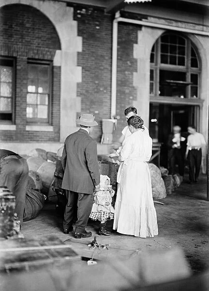 ELLIS ISLAND, 1917. A new immigrant family at Ellis Island. Photograph, March 1917