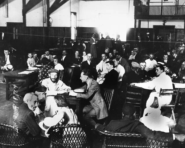 ELLIS ISLAND, 1923. Immigrants in the dining hall at Ellis Island. Photograph, 1923