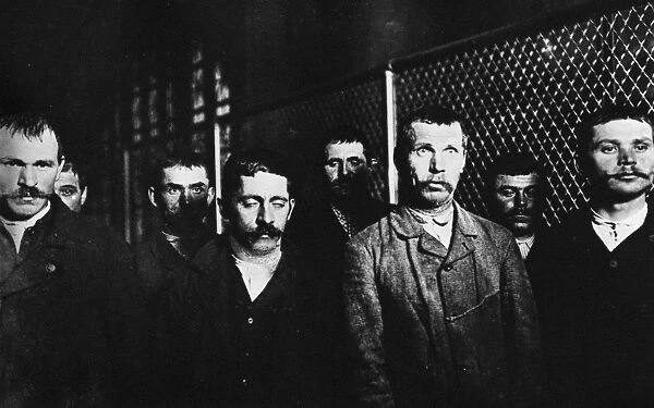 ELLIS ISLAND, c1910. A group of immigrant men waiting in the registry room at Ellis Island